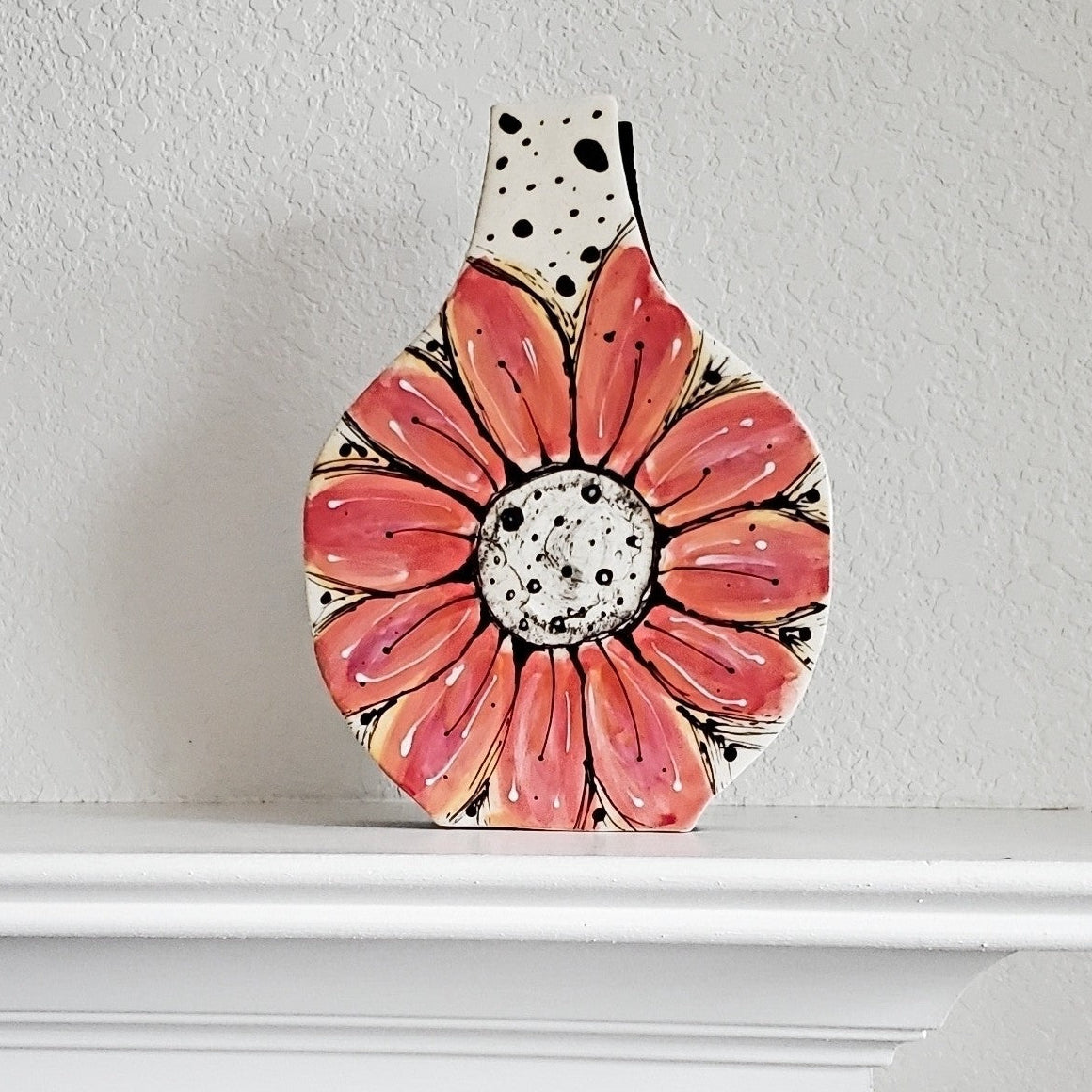 Fine art suclpture with a floral design on a white surface